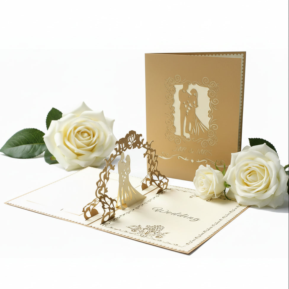 The 3D Pop-Up Wedding Card – Gold Bridal Couple Greeting Card for Weddings, Anniversaries & Invitations, featuring a couple silhouette on a white background with white roses.