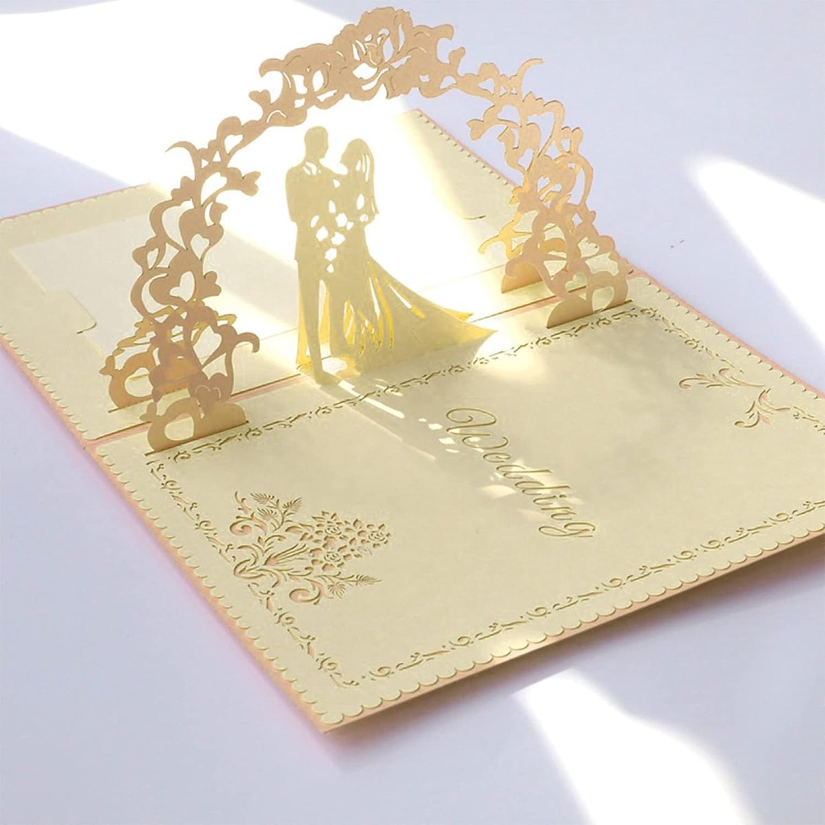 Decorative wedding card with a 3D cutout of a couple on a white background