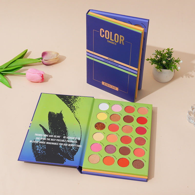 The 72 Colour Eyeshadow Palette Book Blue Edition –  Matte, Shimmer & Wet Powder Makeup Set featuring colourful shades with decorative blue packaging on a beige surface.