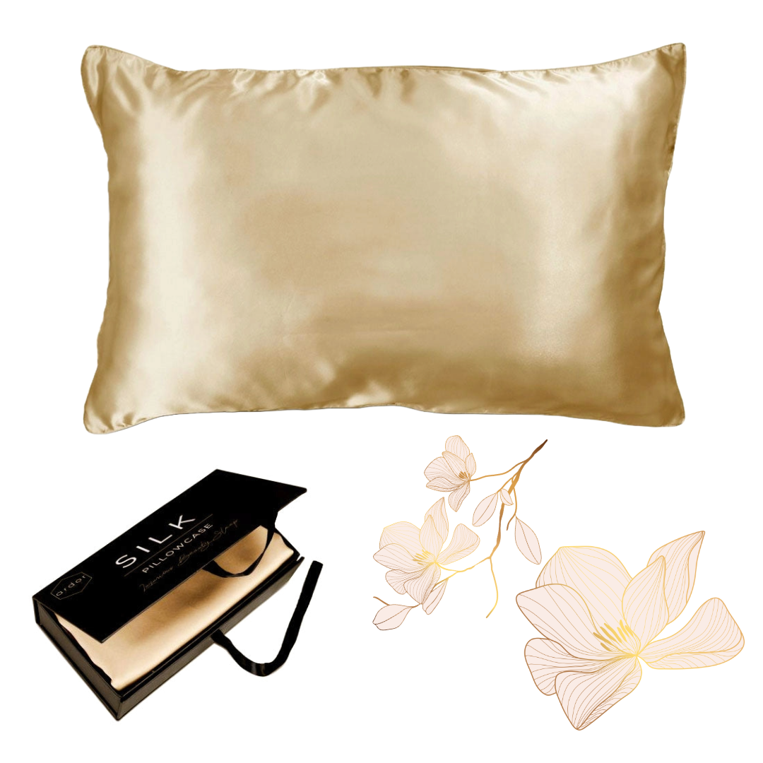 The Ardor Mulberry Silk Standard Pillowcase Golden Princess displayed alongside its packaging and a decorative flower, suggesting a luxurious and elegant product intended for comfort and style in bedroom decor.