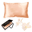 The Ardor Mulberry Silk Standard Pillowcase Peach Spritz displayed alongside its packaging and a decorative flower, suggesting a luxurious and elegant product intended for comfort and style in bedroom decor.