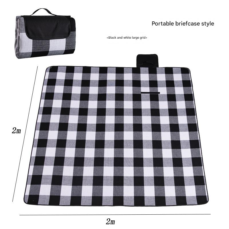 Black and white checkered picnic blanket with dimensions and a portable briefcase style option.