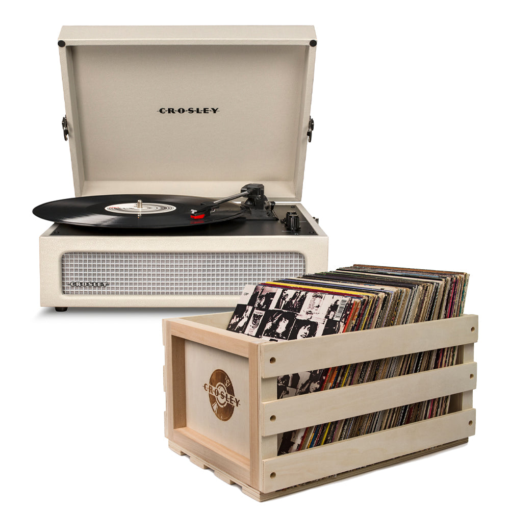 Crosley Voyager Dune - Bluetooth Portable Turntable in beige colour with a Crosley Record Storage Crate made of wood, displaying a collection of vinyl records.