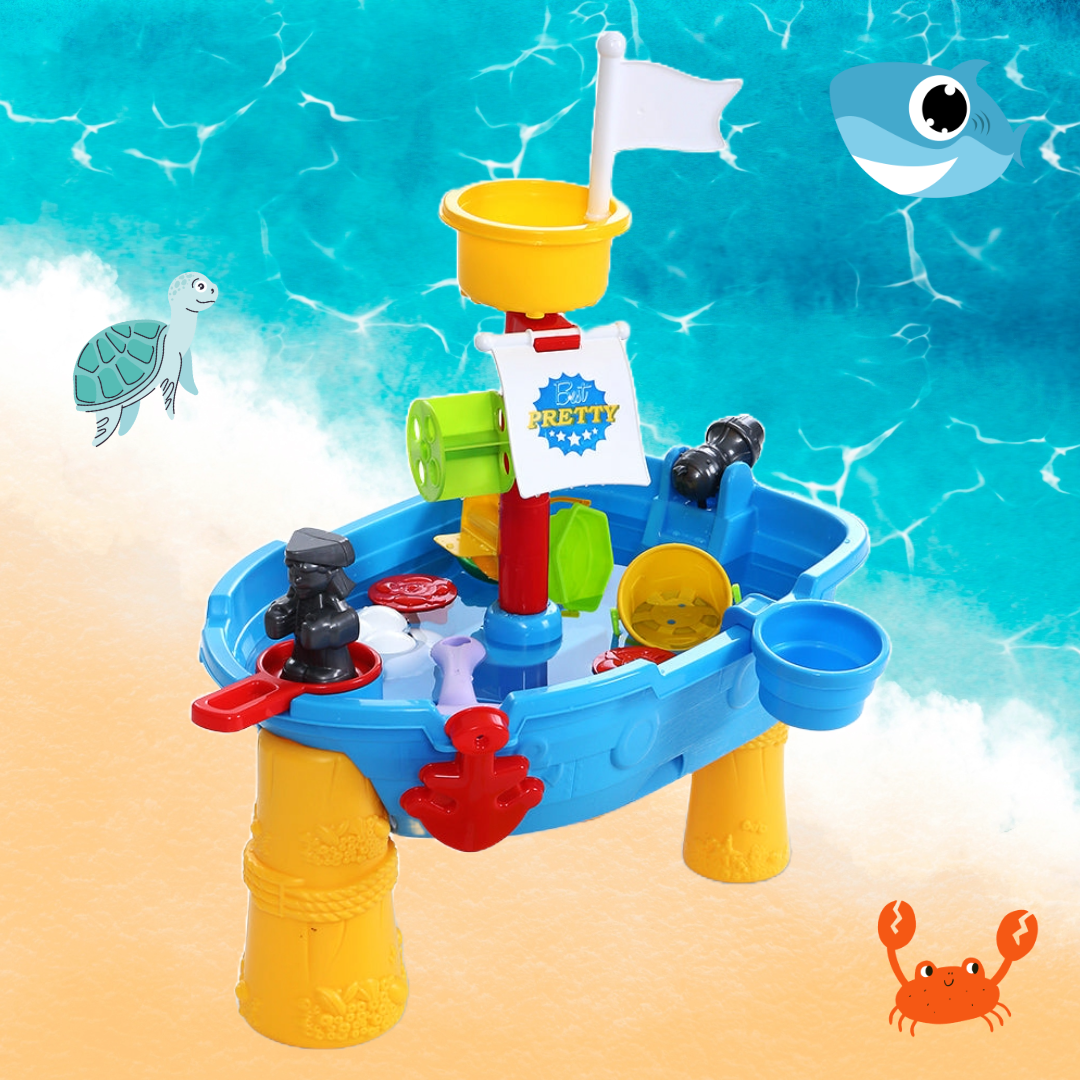 The Keezi Kids Pretend Pirate Ship Sandpit and Water Activity Play Set featured on a beach with a cartoon shark, turtle, and crab nearby.