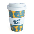 The King Dad Eco-to-Go Bamboo Travel Mug with a blue background, featuring a pattern of golden 'No. 1 DAD' trophies, crowns, and stars.