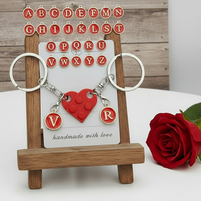 The Personalised Initial Matching Heart Brick Keychain Set – Customisable Couples Gift with Interlocking Keyrings (A–Z Letters) featured on a wooden display board with a 'handmade with love' product display card