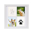 The Pet Paw Print Kit DIY Photo Frame for Dogs & Cats Keepsake, a white photo frame with four sections displaying photos of a dog and their paw prints.