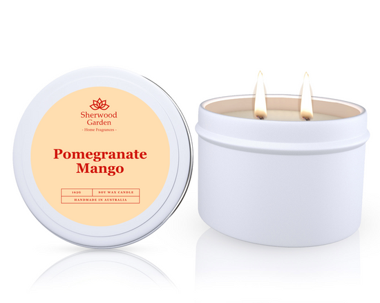 The Pomegranate Mango Soy Candle Tin 165g, featuring a candle in a white tin labeled 'Pomegranate Mango' by Sherwood Garden on a white background