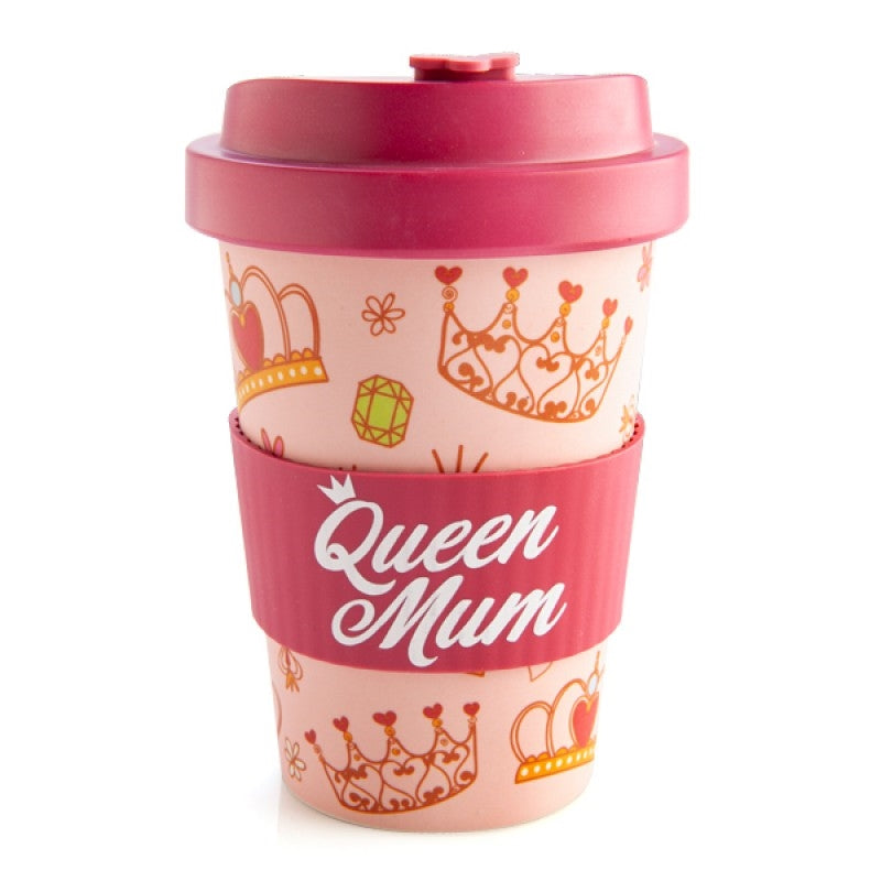 The Queen Mum Eco-to-Go Bamboo Travel Mug in pink with a pattern of crowns, jewels, flowers, and hearts, featuring a magenta anti-spill lid and a silicone band with 'Queen Mum' text in cursive font.