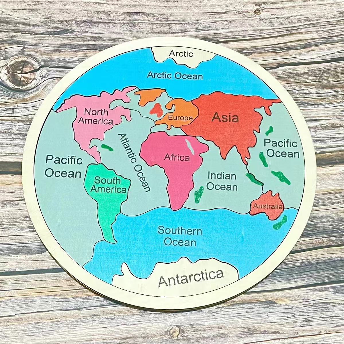 Seven Continents Wooden Jigsaw Puzzle for learning set on a wooden surface