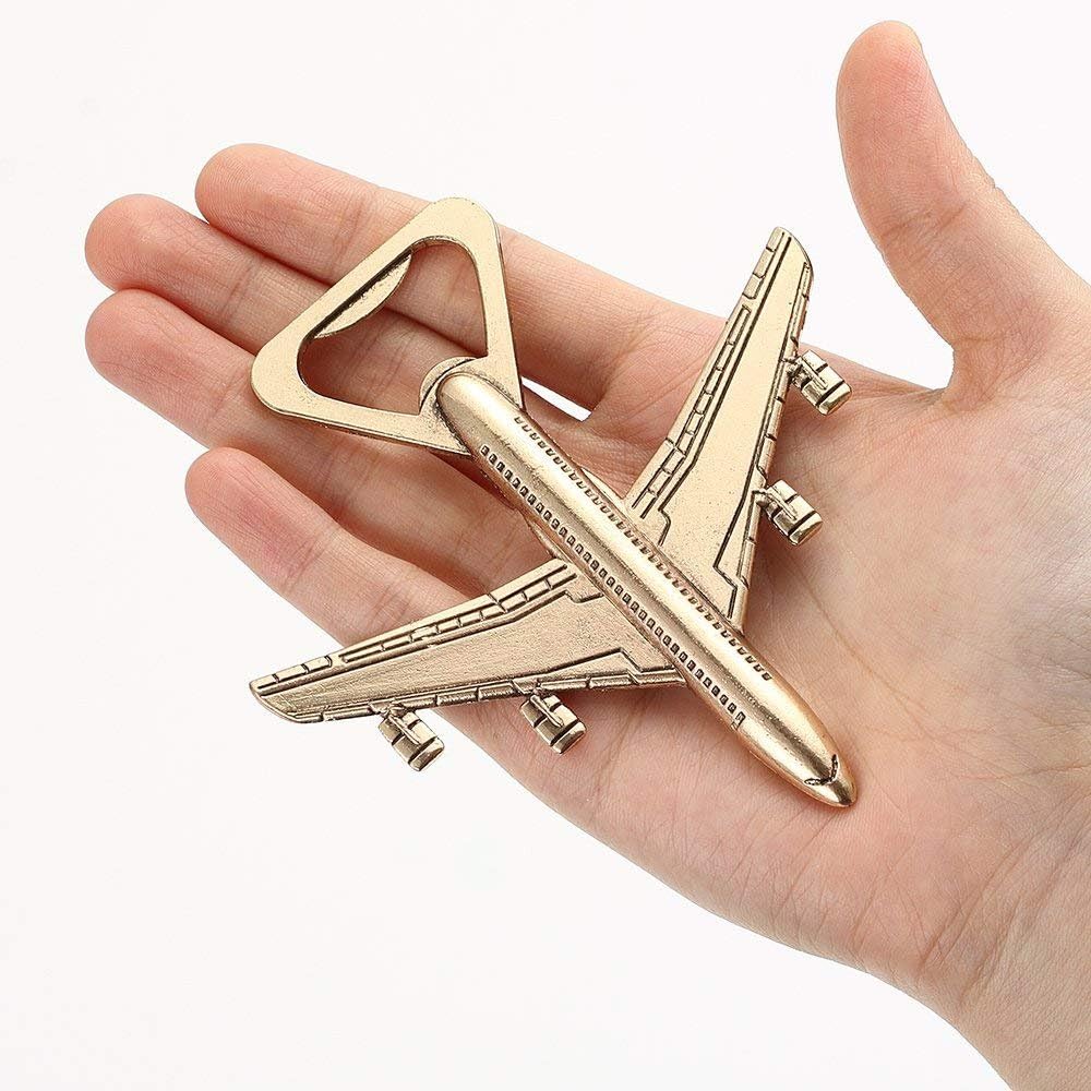 Gold-tone airplane-shaped bottle opener held in a hand against a white background